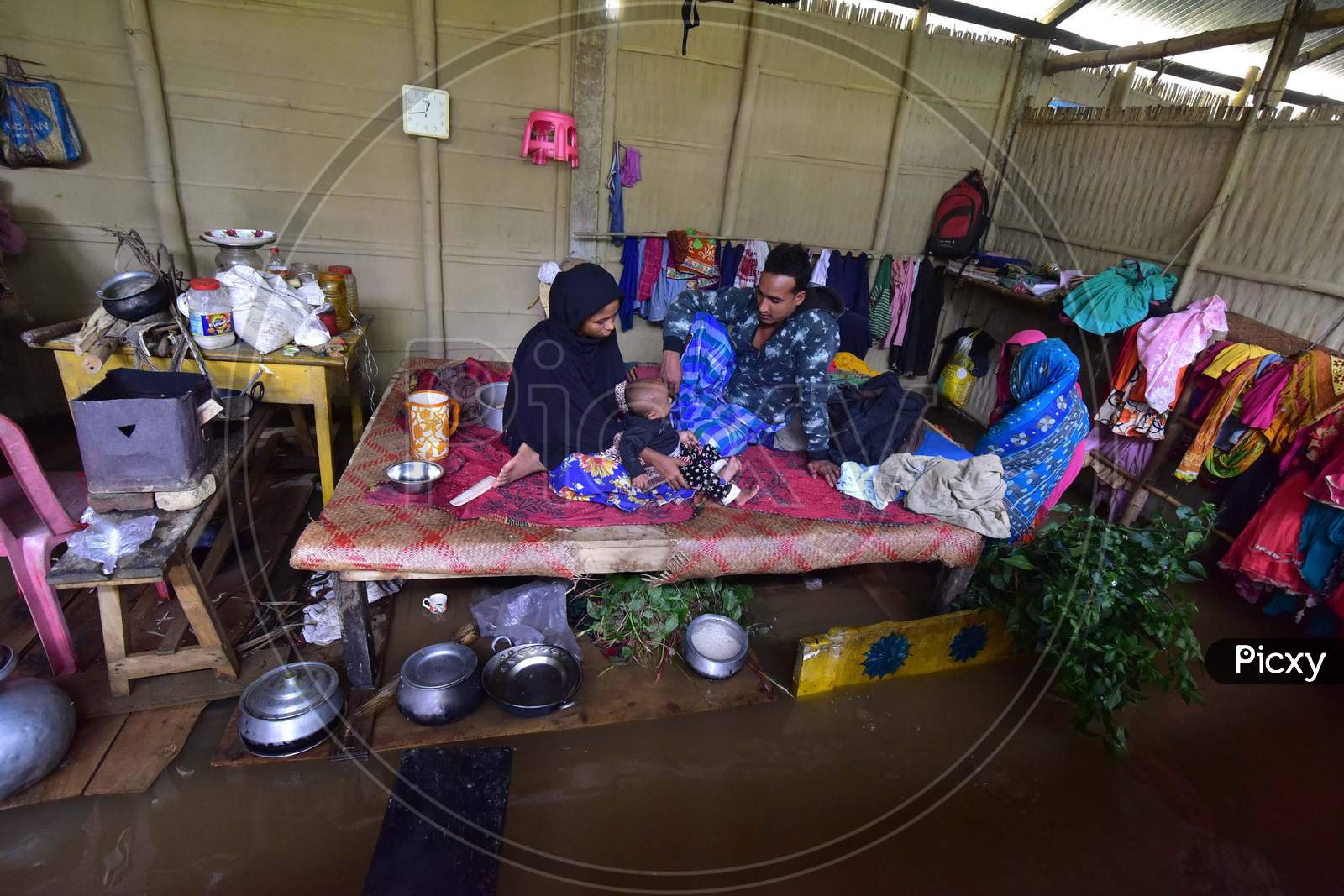 A Family Takes Shelter On A Bed Inside their Submerged House At At Flood Affected Bakulguri Village Near Kampur In Nagaon District Of Assam On May 27, 2020.