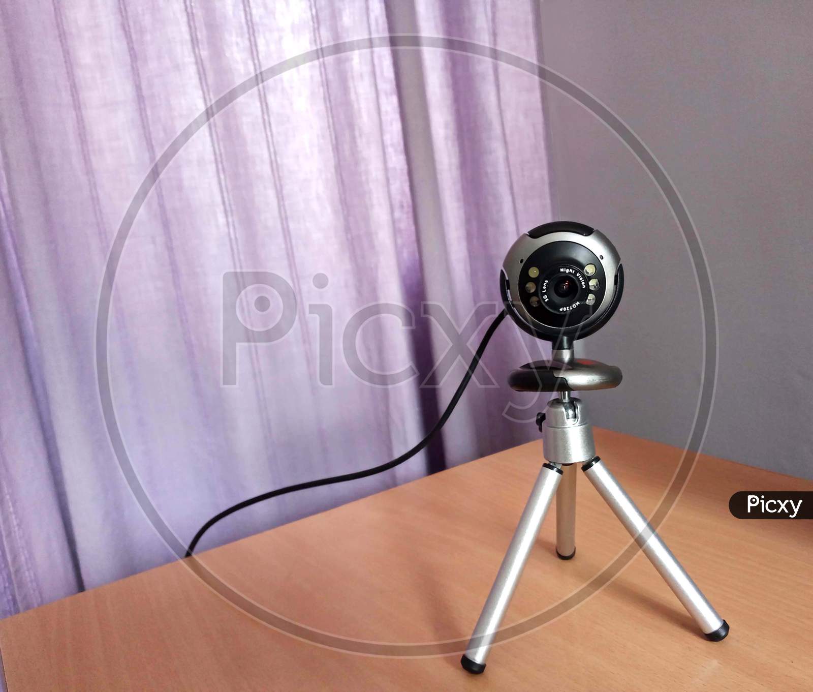 Webcam with stand in front of the computer