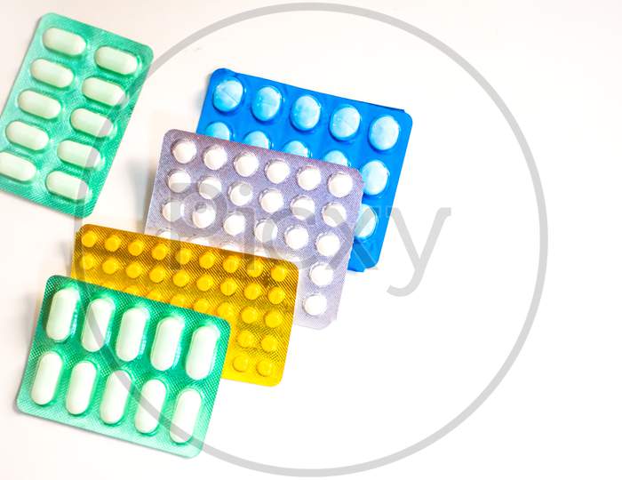 Colorful Many pills and tablets isolated on white background, pharmaceuticals antibiotic drug capsule pills in package.
