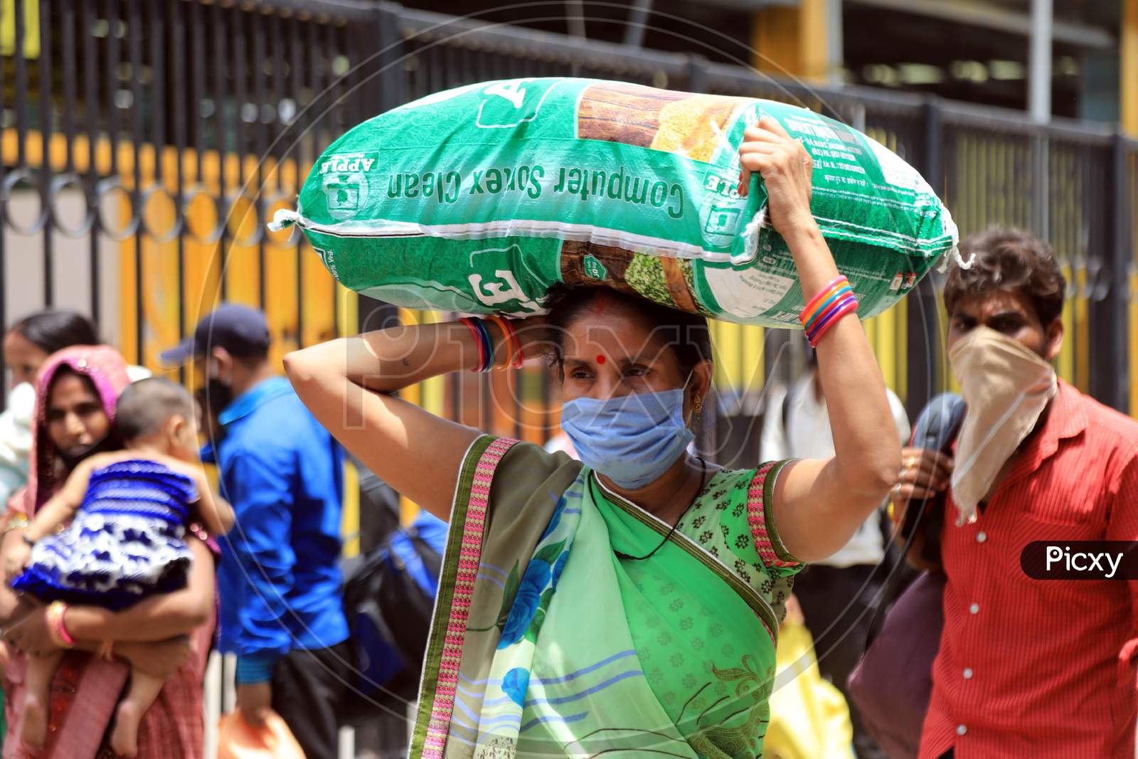 A Migrant Woman Carries Luggage On Her Head As She Walks To Reach A Bus  During extended Nationwide Lockdown amidst  Coronavirus or COVID-19 Pandemic  In Prayagraj, May 27, 2020.
