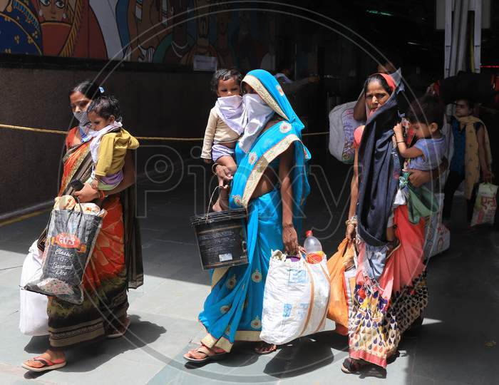 Migrant Women Carry Children As they Walk On The Road On A Hot Day During extended Nationwide Lockdown amidst  Coronavirus or COVID-19 Pandemic  In Prayagraj, May 27, 2020.