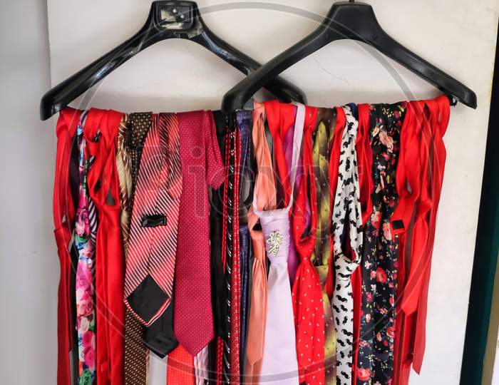 Colorful Male tie hanging on the rack collection for men's hanging inside a shop. Set of stylish men accessories, men's fashion, different neckties. Concept for fathers day.