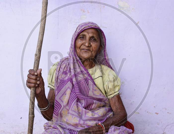 Narsinghpur, Madhya Pradesh/India : May 14, 2020 - A Traditional Indian Women Holding A Stick In Her Hand For Walking In A Rural Area