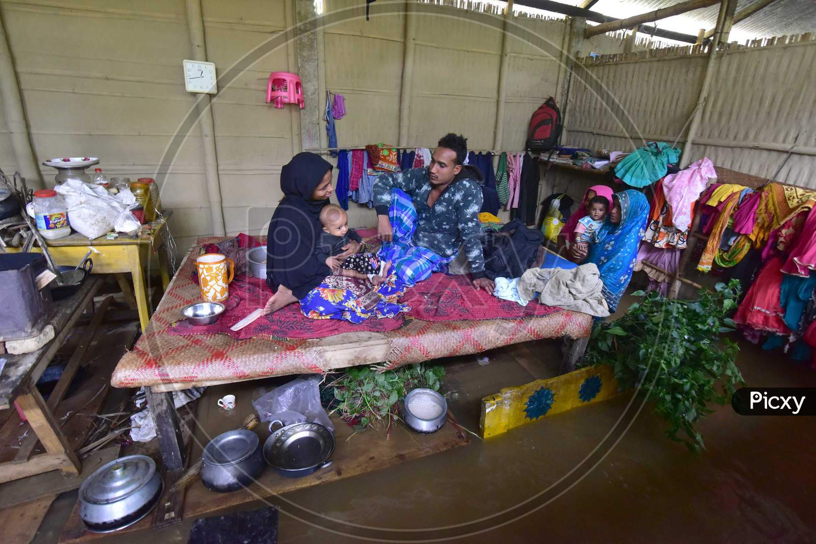 A Flood Affected Family  Takes Shelter  On A Bed Inside His Submerged House At   At Flood Affected Bakulguri Village Near Kampur In Nagaon District Of Assam On May 27,2020