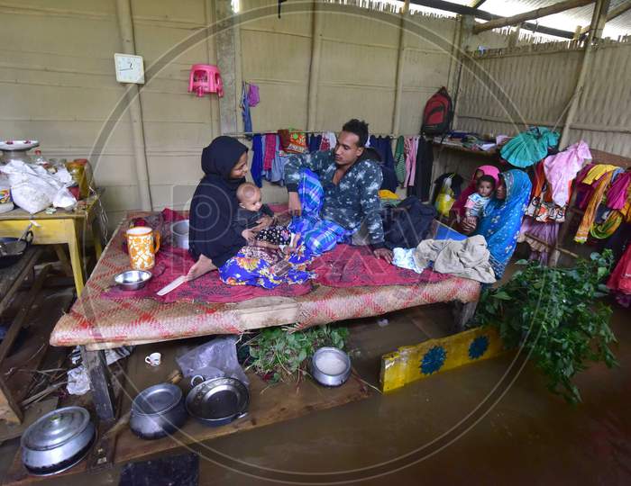 A Flood Affected Family  Takes Shelter  On A Bed Inside His Submerged House At   At Flood Affected Bakulguri Village Near Kampur In Nagaon District Of Assam On May 27,2020