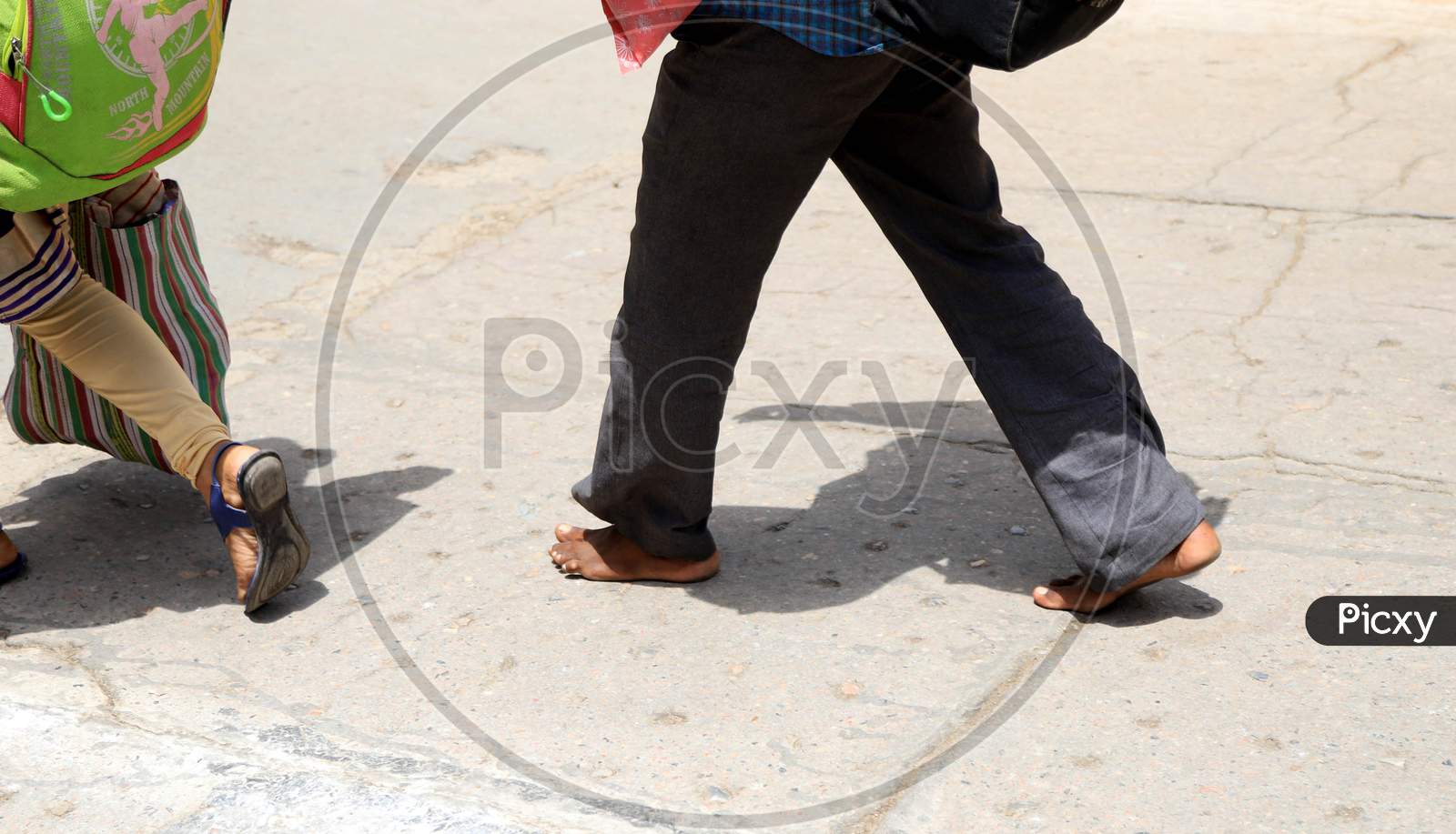 Image of A Migrant walks Naked Feet On The Road On A Hot Day During  extended Nationwide Lockdown amidst Coronavirus or COVID-19 Pandemic In  Prayagraj, May 27, 2020.-LJ622317-Picxy