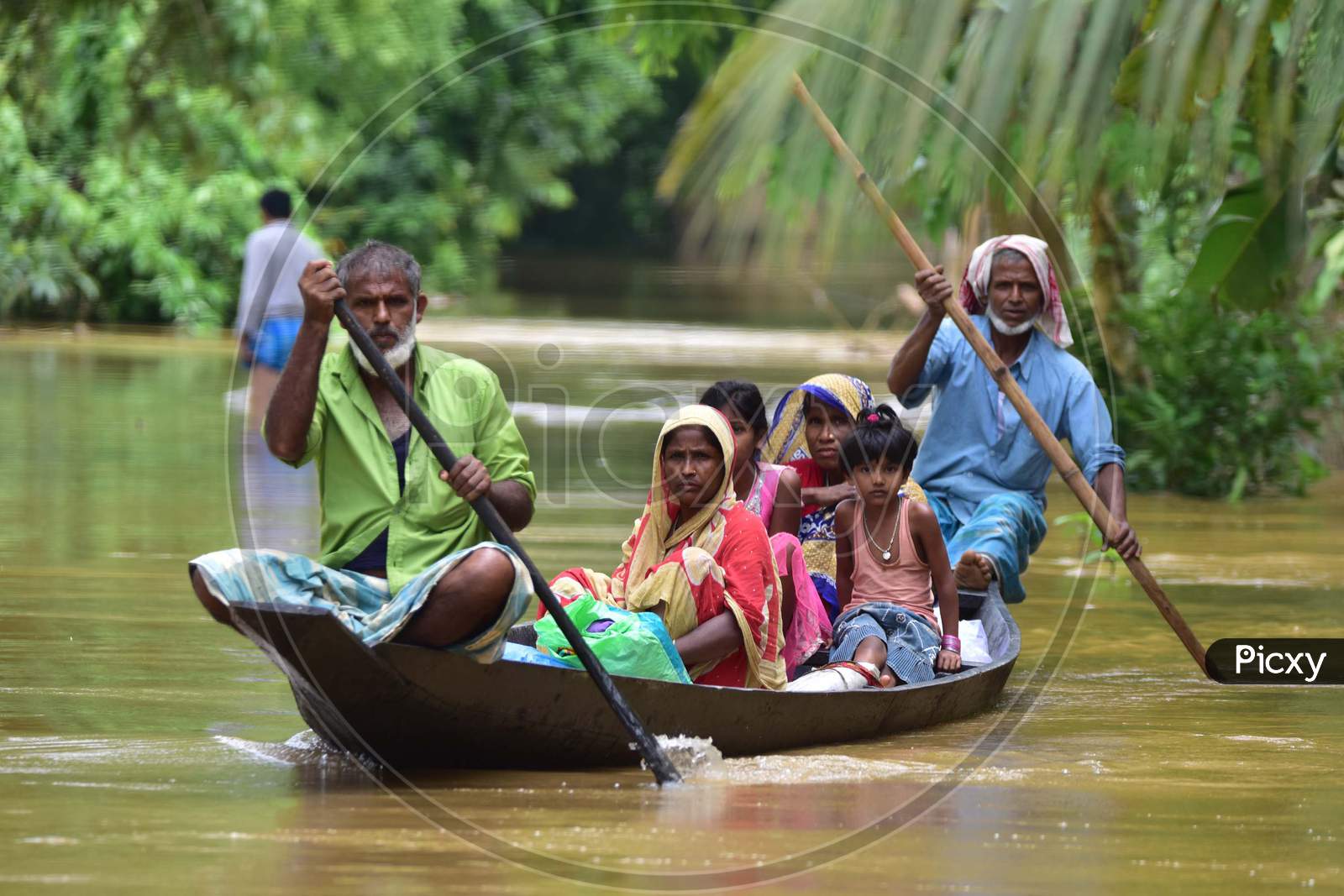 Villagers Are Transported On A Boat Towards A Safer Place  At Flood Affected Bakulguri Village Near Kampur In Nagaon District Of Assam On May 27,2020.