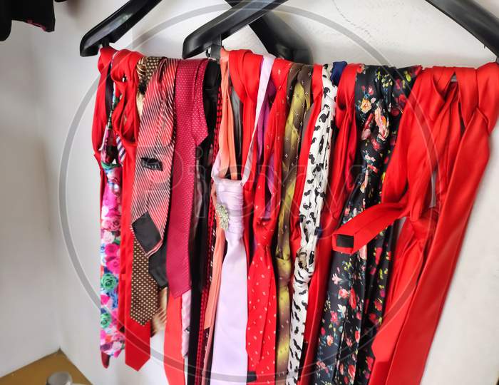 Colorful Male tie hanging on the rack collection for men's hanging inside a shop. Set of stylish men accessories, men's fashion, different neckties. Concept for fathers day.