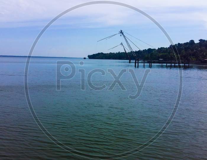 Panoramic Scenery Of Ashtamudi Lake In Kerala With Traditional Chinese Fishing Net For Fishing.