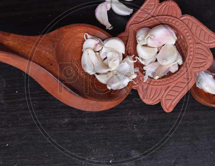One whole aromatic white garlic isolated on black background