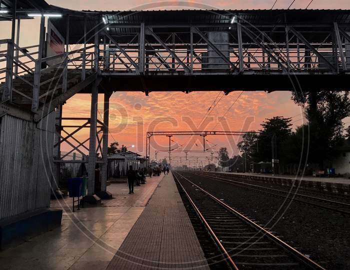 Indian Railway Station Platform Against Dramatic Sunset