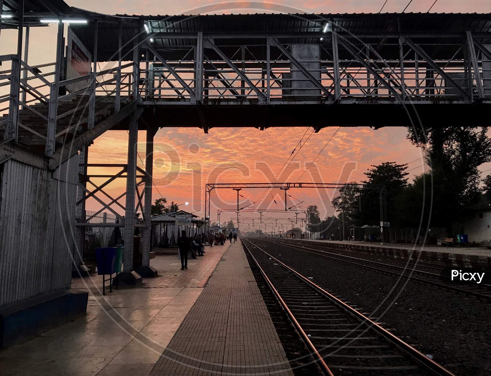 Indian Railway Station Platform Against Dramatic Sunset