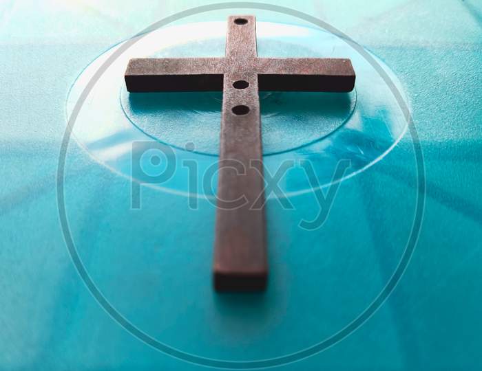Image of wooden cross on blue background. Easter concept.