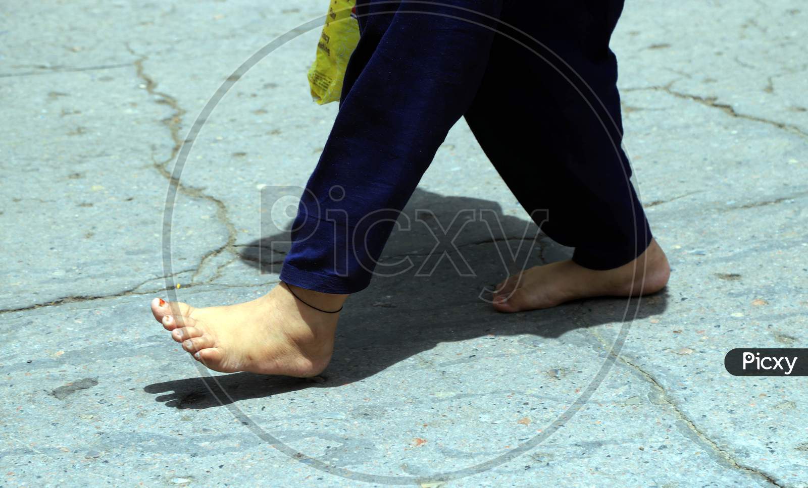 Image of A Migrant worker walks Naked Feet On A Hot Day During A Nationwide  Lockdown In Wake Of Coronavirus In Prayagraj, May 27, 2020.-UL612477-Picxy