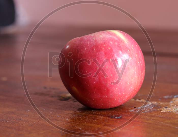 Fresh red apple isolated on wood background
