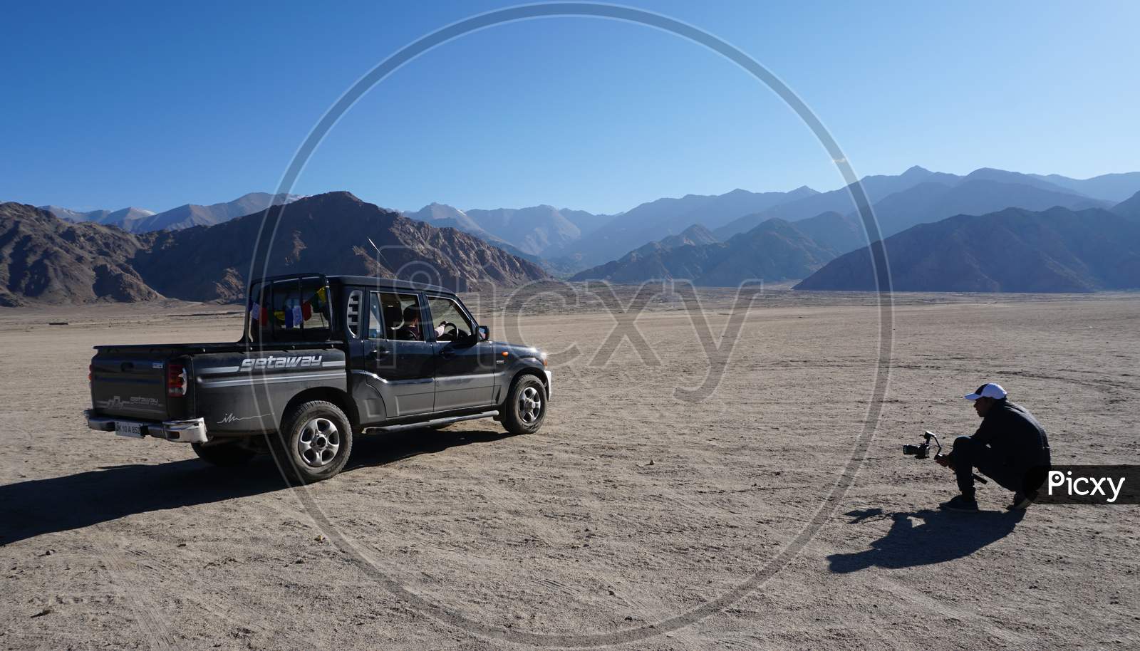 Man Clicking Picture Of A Jeep In Leh Mountains