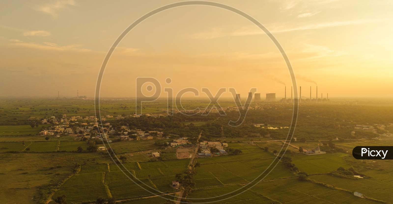 Aerial View Of Coal Power Plant - Sunrise Near Green Agriculture Field With Factories Outside The City, Raichur, India