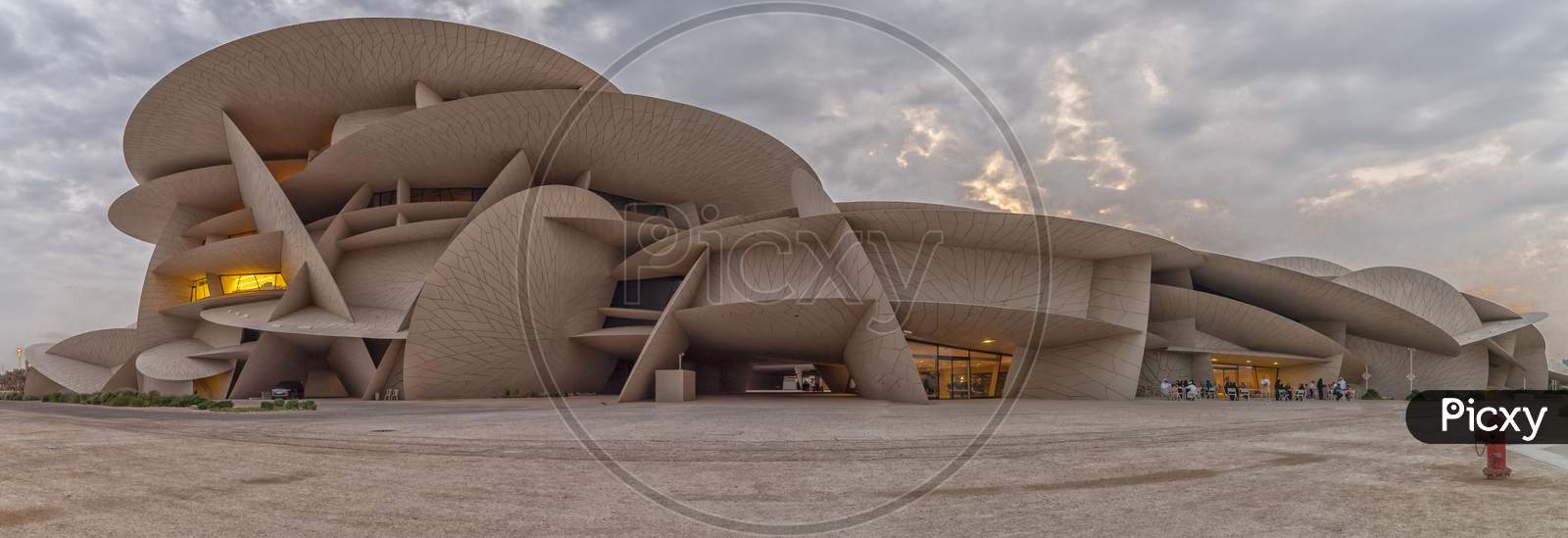 National Museum of Qatar (Desert rose) panoramic  view at sunset with clouds in the sky