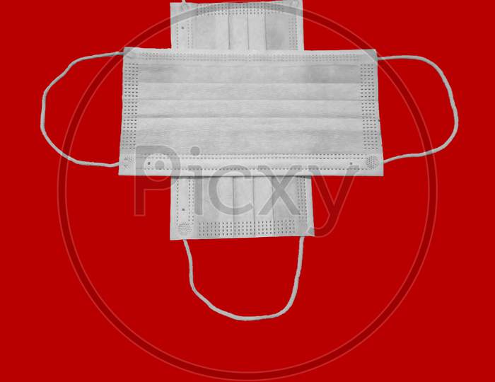 A Pair Of Medical Mask Isolated On Red Background