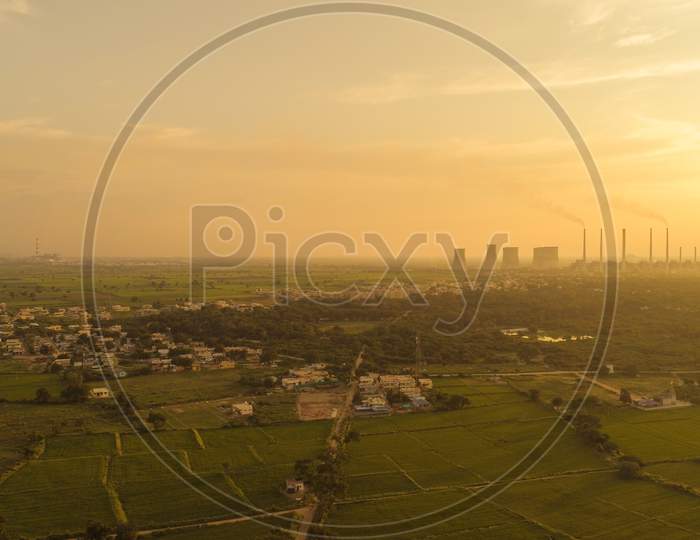 Aerial View Of Coal Power Plant - Sunrise Near Green Agriculture Field With Factories Outside The City, Raichur, India