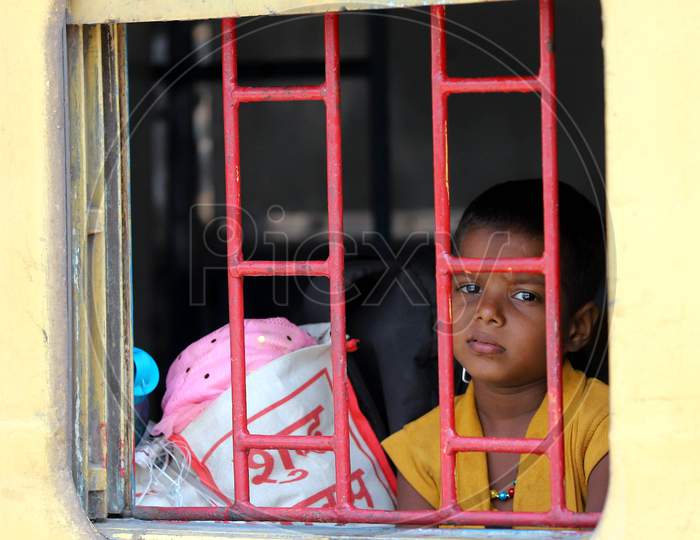 A Migrant Child peeps out from a Window And Looking Through it from Migrants Special Train During Extended Nationwide Lockdown Amidst Coronavirus Or COVID-19 Pandemic in Prayagraj