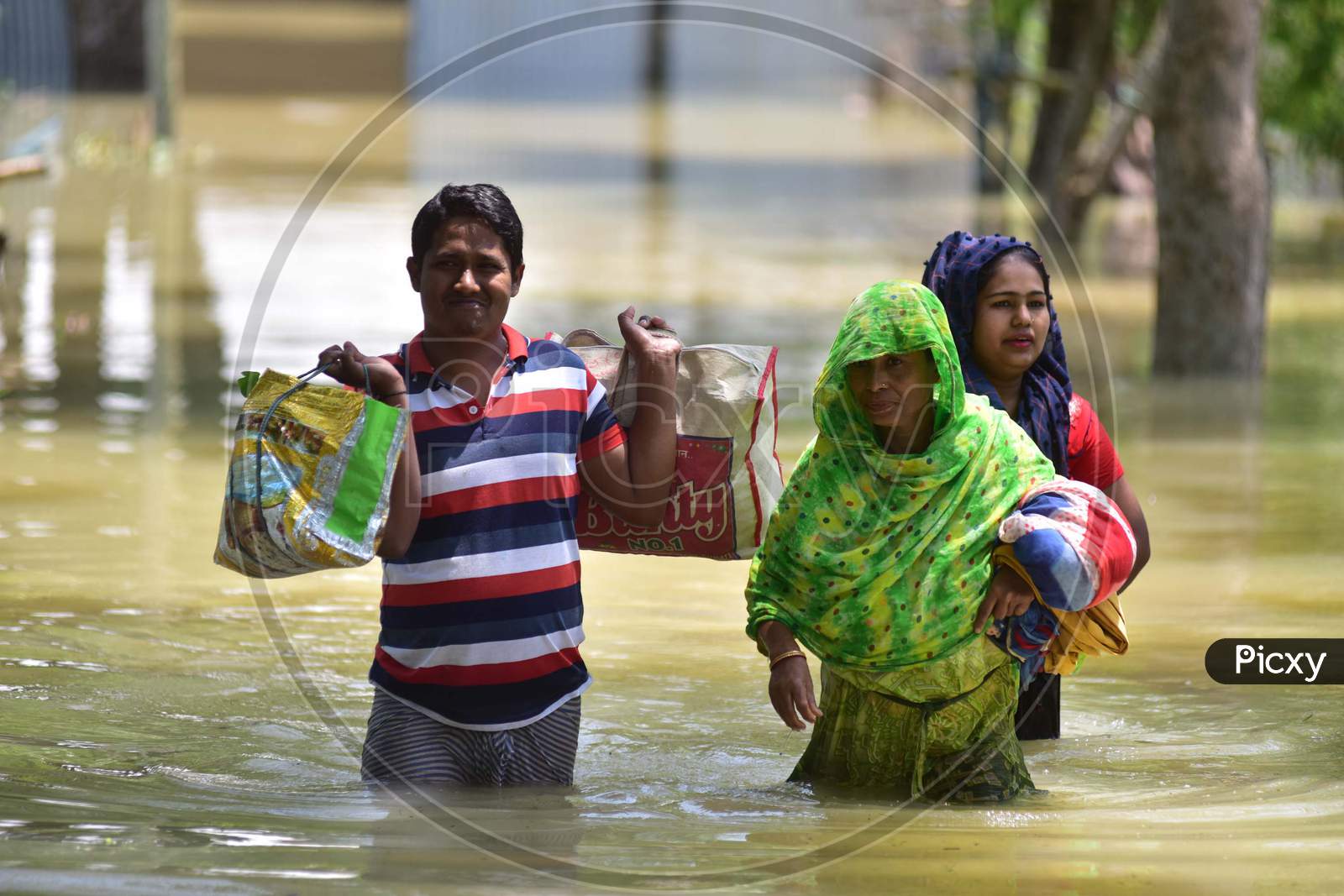 Villagers  Wade Through A Flooded Area To Reach A  Safer Place At Doboka  In  Hojai  District Of Assam  On May 28,2020.