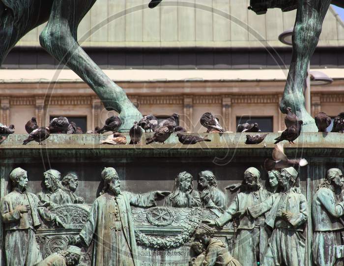 Pigeons At The Feet Of Prince Michael Statue