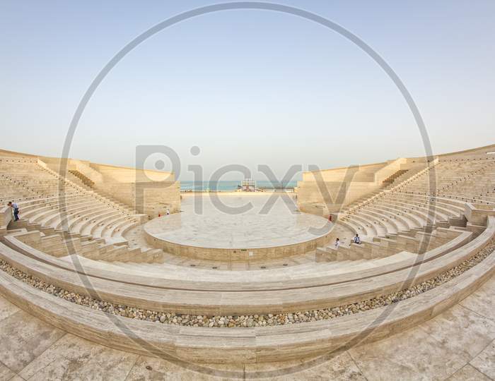 The amphitheater in Katara Cultural Village, Doha Qatar panoramic view in daylight with Arabic gulf in background