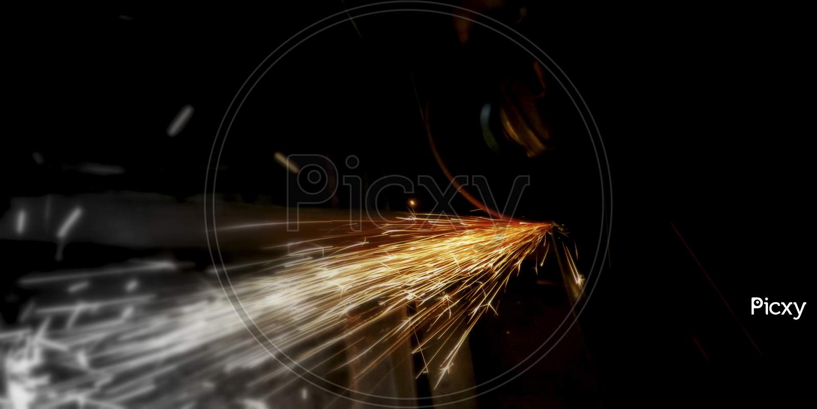 Metal Grinding On Steel Pipe With Flash Of Sparks Close Up