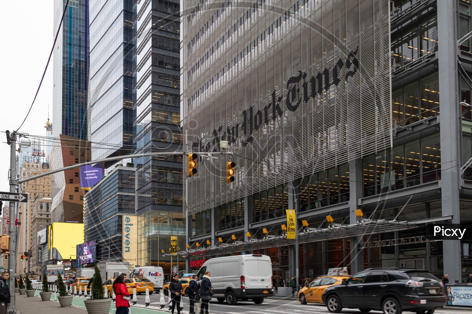 The New York Times newspaper headquarters building in Eighth Avenue; 40th & 41st Street exterior daylight view with people and cars in the street