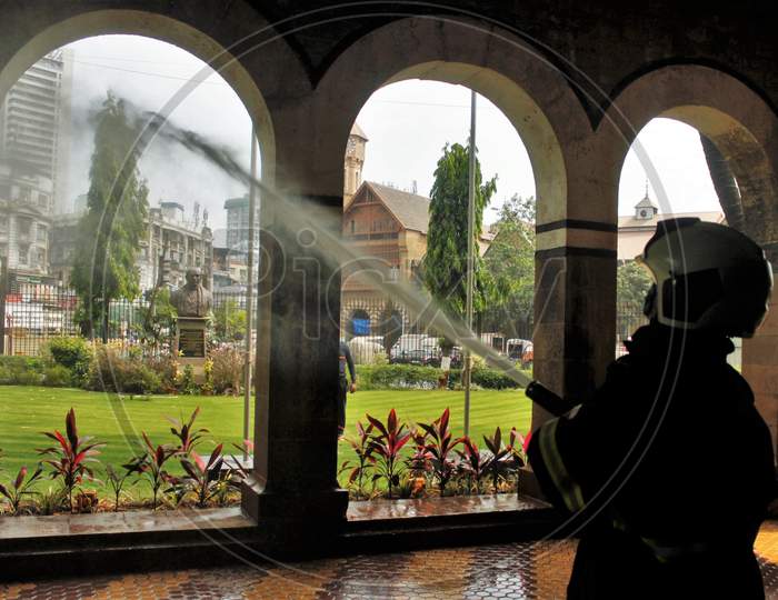 Members of a municipal fire brigade spray disinfectant inside the Police Headquarters area at Crawford market, during the 21- day nationwide lockdown to limit the spreading of coronavirus disease (COVID-19) in Mumbai, India on March 28, 2020.