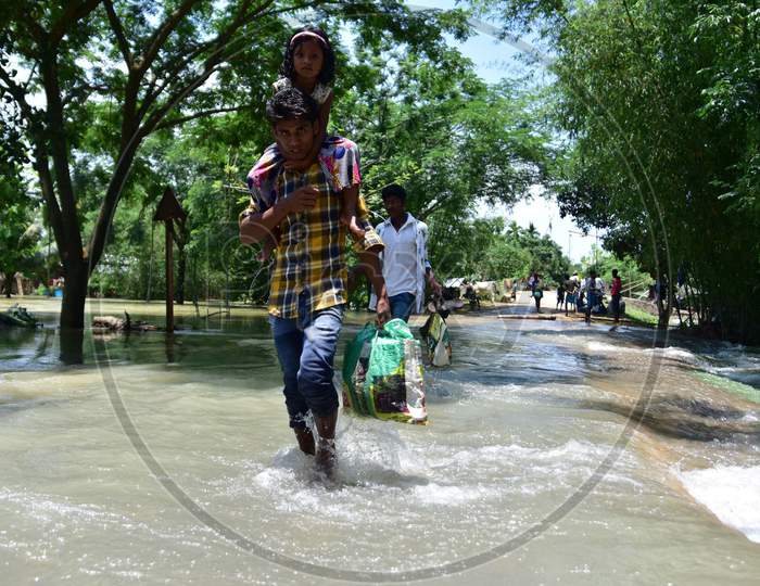 Villagers Wade Through A Flooded Area To Reach A Safer Place At Doboka  In  Hojai  District Of Assam  On May 28,2020.