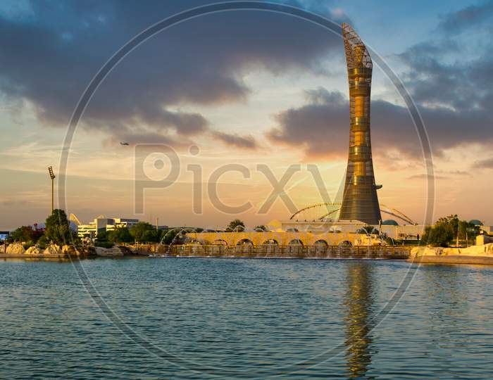 Doha,Qatar-December 7,2019: Aspire park daylight view with fountain and  The Torch Doha Hotel in background