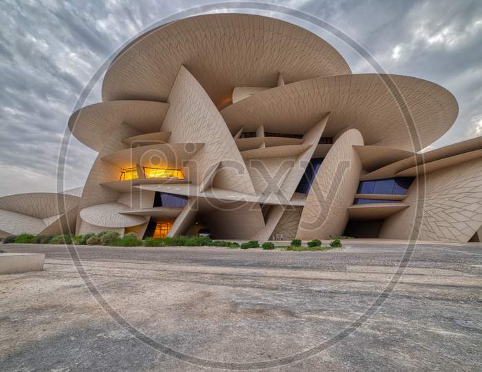 National Museum of Qatar (Desert rose) panoramic  view at sunset with clouds in the sky