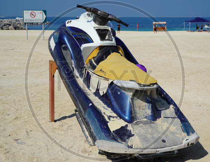 Dirty Old Jet Ski Parked On The Beach Of Holiday Season. Old Jet Skis On The Beach On Wooden Trailer. Blue And White Jet Ski - Dubai Uae January 2020