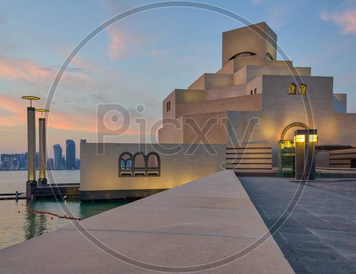 Museum of Islamic Art , Doha,Qatar  exterior view at sunset with clouds in the sky in the background