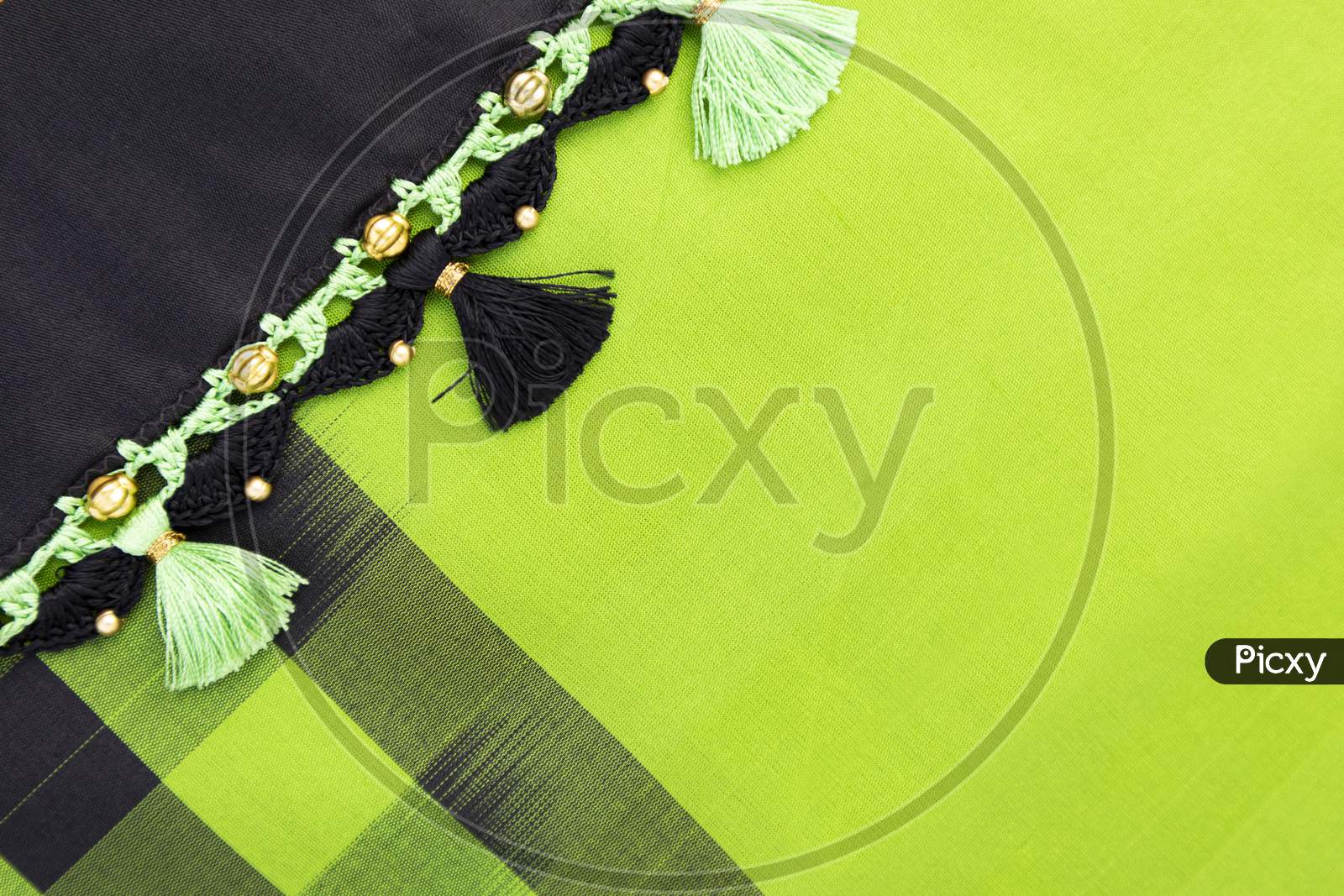 Crochet, Tassel Fashion Designing Works On Black Cloth Border Saree With Checks.