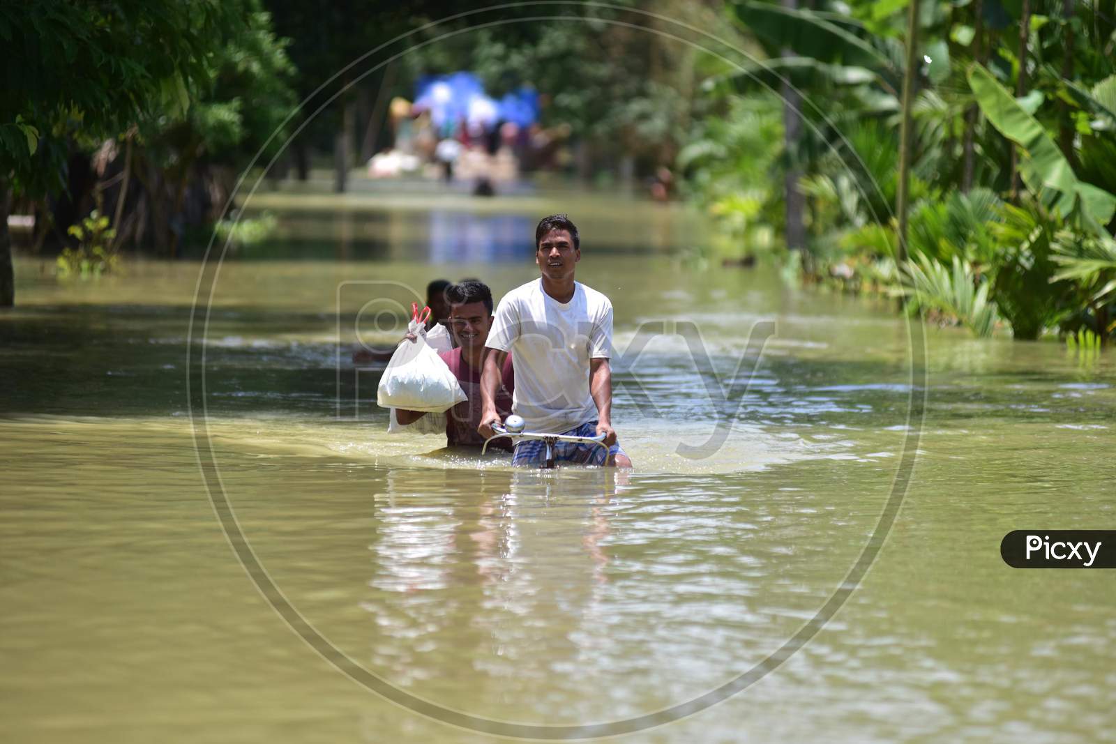 A Man Wade  Through A Flooded Area To Reach A A Safer Place At Doboka  In  Hojai  District Of Assam  On May 28,2020.