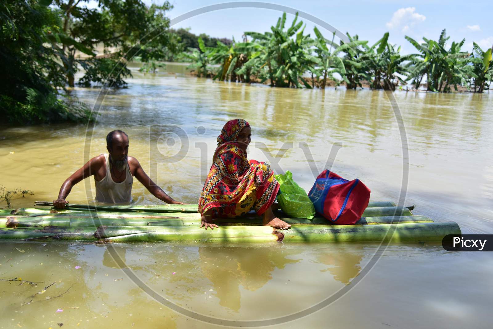 Villagers Using A Makeshift Raft  To Reach  A Safer Place At Doboka  In  Hojai  District Of Assam  On May 28,2020.