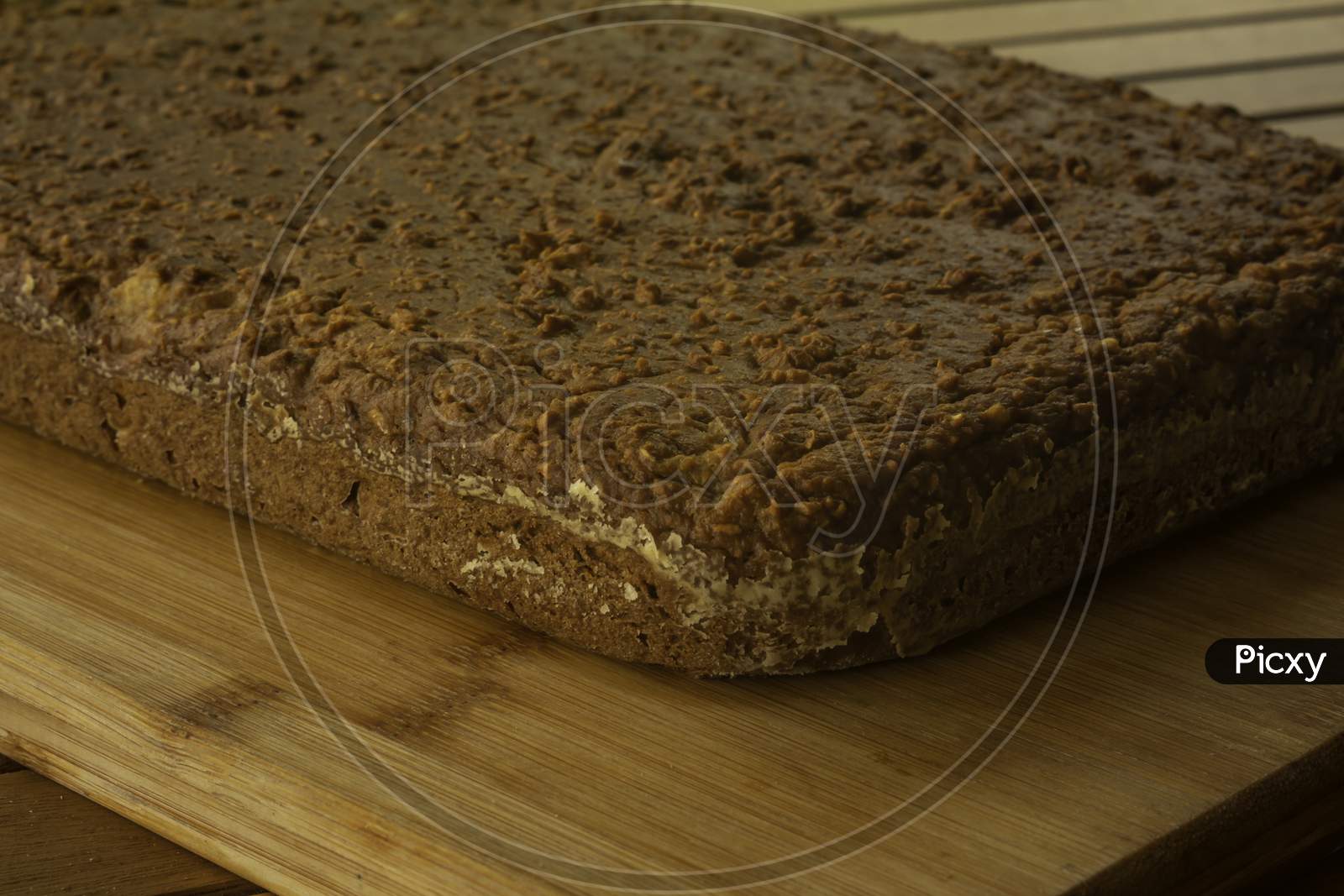 Homemade Brown Cake Made With Cinnamon And Sweet Potato On A Rustic Wooden Board. Selective Focus.