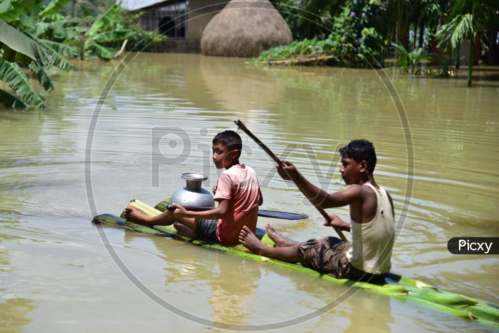 Boys Row A Makeshift Banana Raft At Flood Affected  Doboka  In  Hojai  District Of Assam  On May 28,2020