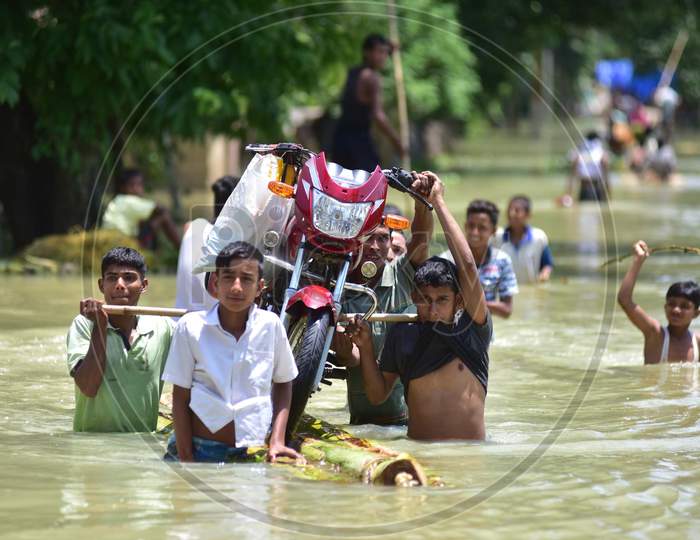 Villagers  Transported A Bike On A Raft Made From Banana Trees  Towards A Safer Place At Doboka  In  Hojai  District Of Assam  On May 28,2020.