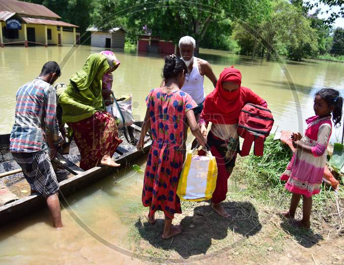 Villagers Are Transported On A Boat Towards A Safer Place At Doboka  In  Hojai District Of Assam  On May 28,2020.