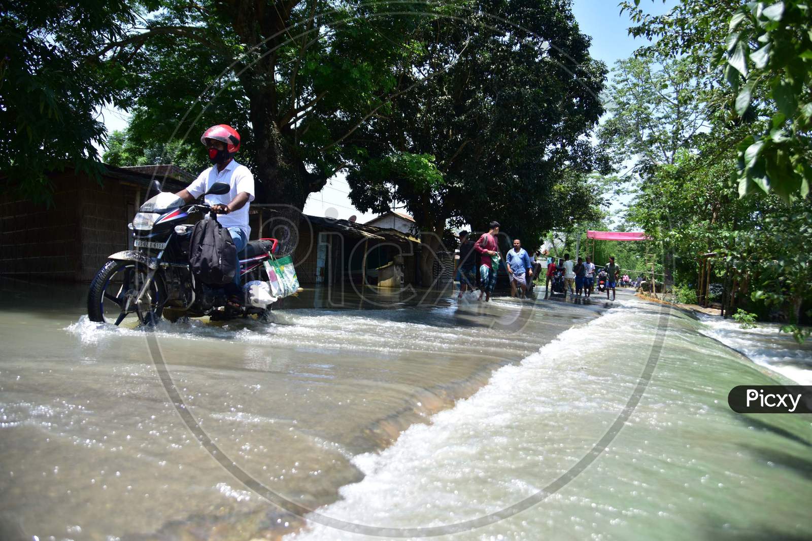 A Man Ride Is Bike Through   A Flood Water  At Doboka  In  Hojai  District Of Assam  On May 28,2020