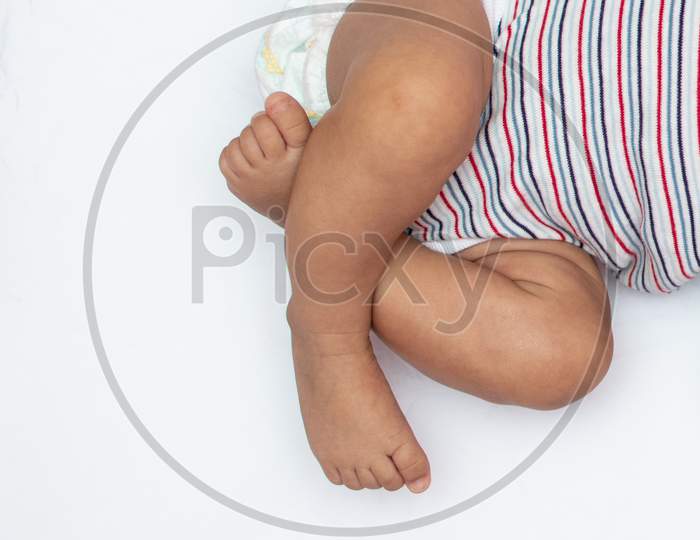 Crossed Legs Of Infant On A White Background