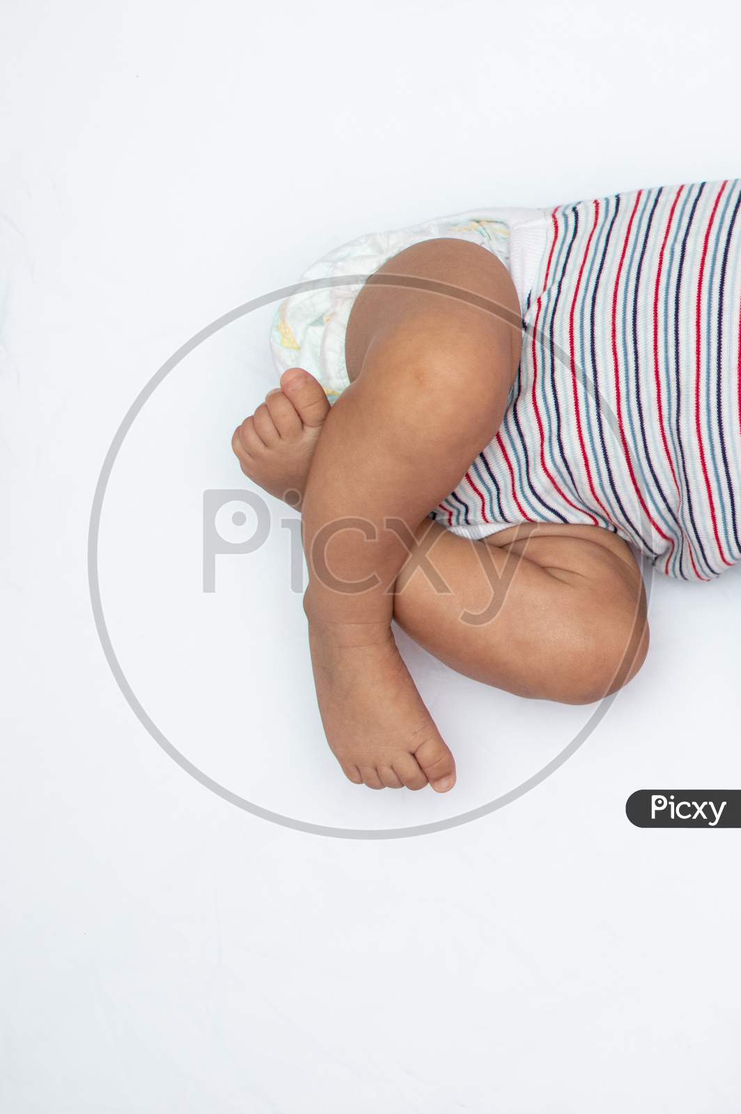 Crossed Legs Of Infant On A White Background