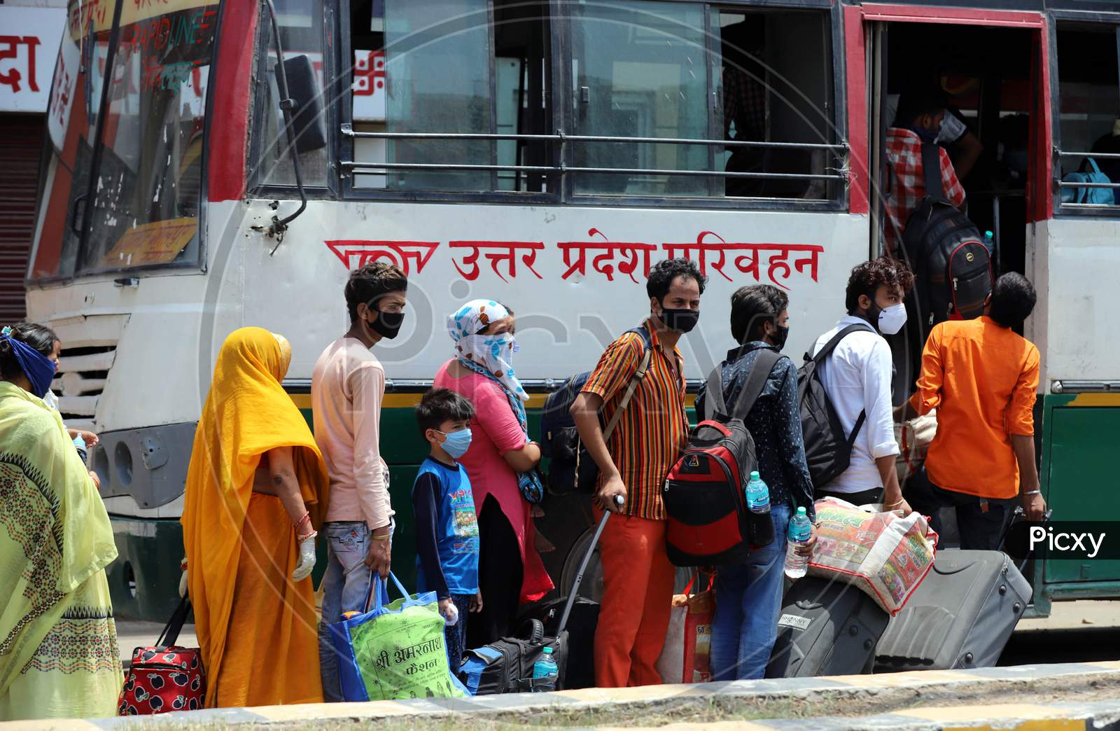 Migrants Board Buses To Their Native Places During Extended Nationwide Lockdown Amidst Coronavirus Or COVID-19 Pandemic in Prayagraj