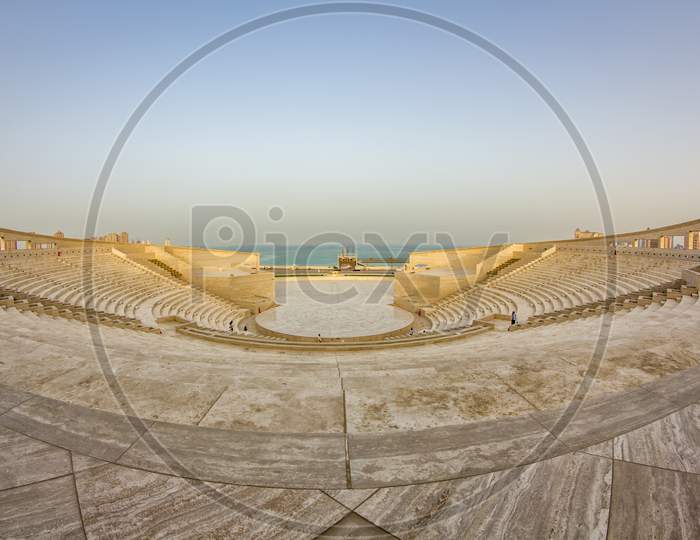 The amphitheater in Katara Cultural Village, Doha Qatar panoramic view in daylight with Arabic gulf in background