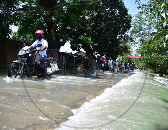 A Man Ride Is Bike Through   A Flood Water  At Doboka  In  Hojai  District Of Assam  On May 28,2020