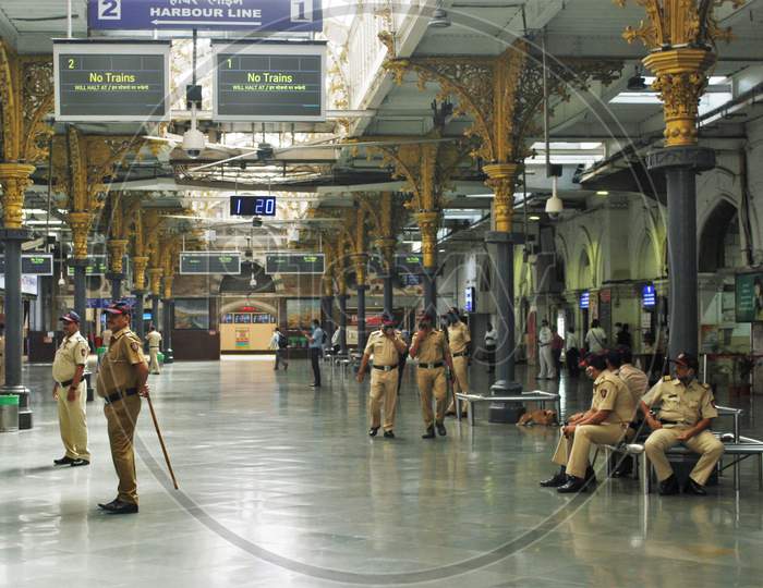 Police personnel are seen at the deserted Chhatrapati Shivaji Maharaj Terminus(CSMT) during the 14-hour long curfew to limit the spreading of coronavirus disease (COVID-19) in the country, in Mumbai, India on March 22, 2020.